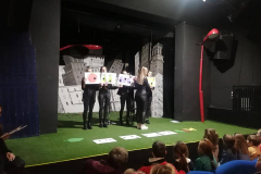 7.	Zasłuchani najmłodsi widzowie oraz studentki na scenie teatru